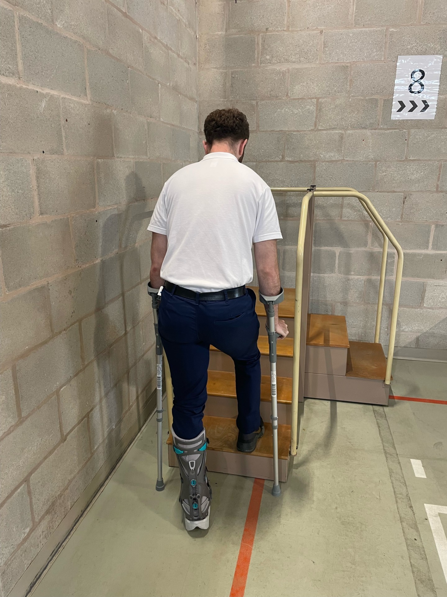 Image of a person demonstrating going upstairs with crutches when there is no handrail